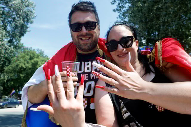 A fan shows off her nails as she arrives at the concert of the Croatian singer Marko Perkovic Thompson, which is poised to break the world record for largest paid concert in Zagreb, Croatia, July 5, 2025. REUTERS/Borut Zivulovic