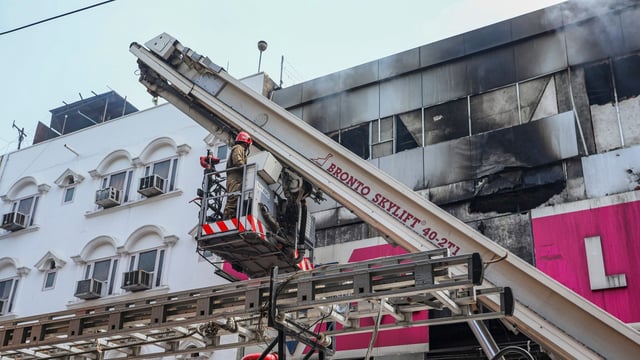 Fire personnel at a Vishal Mega Mart showroom, where a fire broke out on Friday, at Karol Bagh area, in New Delhi, Saturday, July 5, 2025.