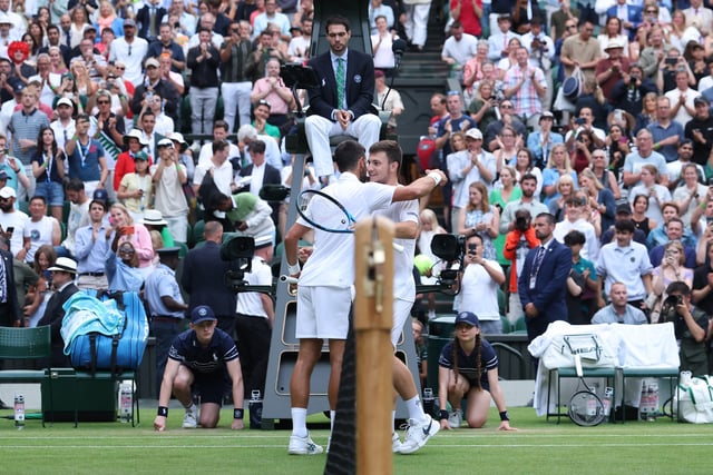 Tennis - Wimbledon - All England Lawn Tennis and Croquet Club, London, Britain - July 5, 2025 Serbia's Novak Djokovic with Serbia's Miomir Kecmanovic after winning his third round match REUTERS/Toby Melville