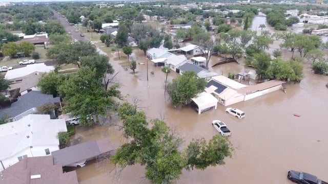 A drone view shows houses flooded following torrential rains that unleashed flash floods along the Guadalupe River in San Angelo