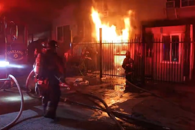 Oakland firefighters battle a blaze on the 1600 block of 78th Avenue caused by illegal fireworks Friday night, in an image taken from video. 