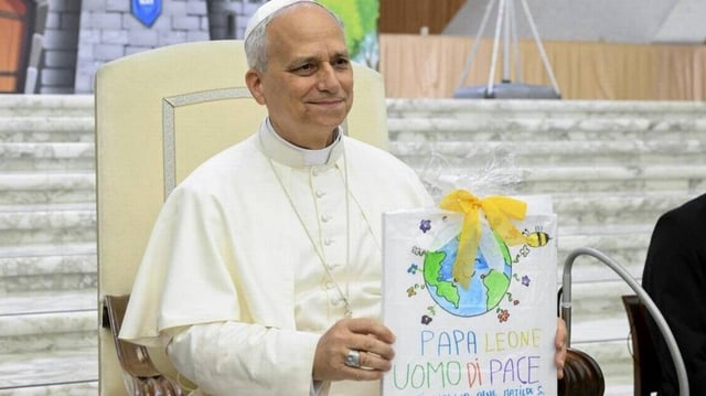Pope Leo XIV holds a drawing during an audience with children and young people during the 'Estate Ragazzi in Vaticano' summer camp in Vatican City on Thursday. Photo by Vatican Media/EPA