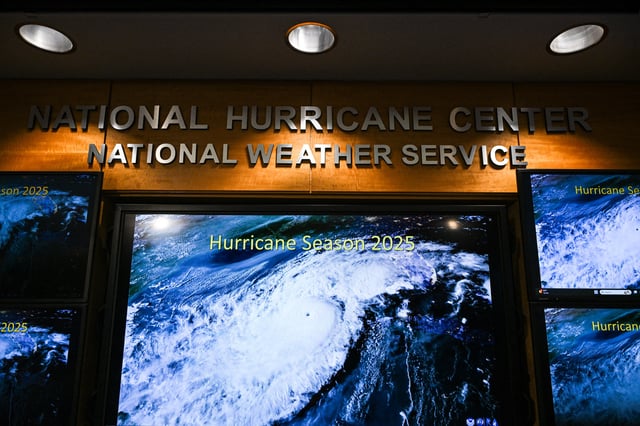 Monitors display hurricane models during a news conference at the National Oceanic and Atmospheric Administration&#39;s (NOAA) National Hurricane Center (NHC) in Miami, Florida, on May 30, 2025.