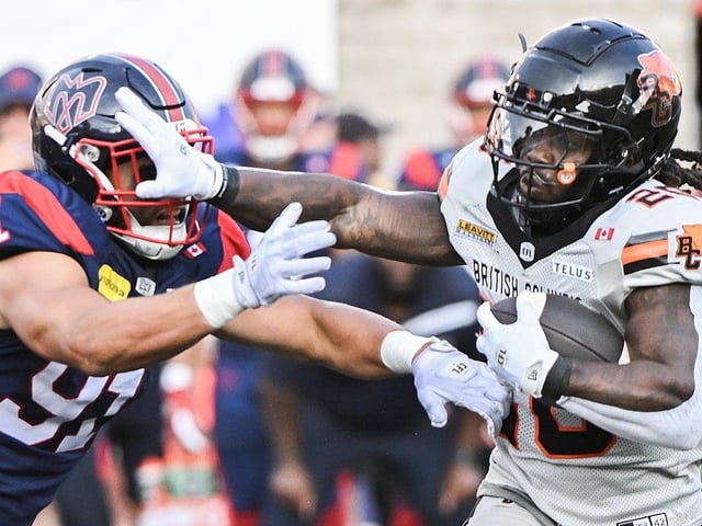  B.C. Lions’ James Butler holds off a challenge from Montreal Alouettes’ Isaac Adeyemi-Berglund during CFL game in Montreal, Saturday, July 5, 2025.