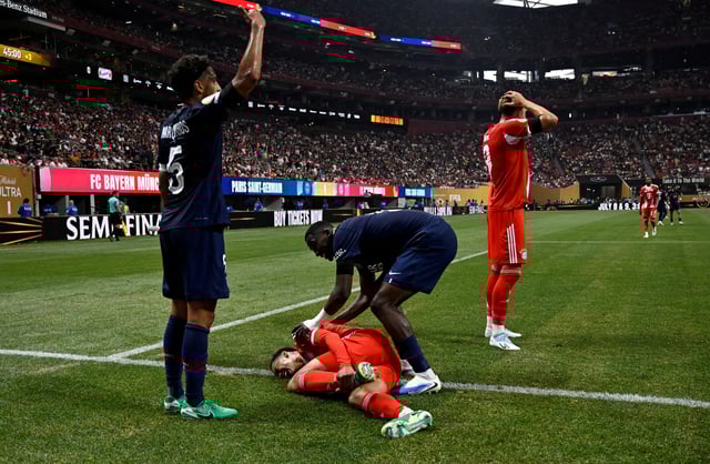 Soccer Football - FIFA Club World Cup - Quarter Final - Paris St Germain v Bayern Munich - Mercedes-Benz Stadium, Atlanta, Georgia, U.S. - July 5, 2025 Bayern Munich's Jamal Musiala sustains an injury after a collision with Paris St Germain's Gianluigi Donnarumma  REUTERS/Pablo Morano/File Photo