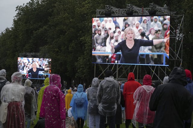 Artistic director of the Song Celebration Heli Jurgenson, seen on the screens, attending the Estonian Song Festival, part of the "Iseoma" Song and Dance Celebration, at the Song Festival Grounds in Tallinn, Estonia, Saturday, July 5, 2025. (AP Photo/Sergei Grits)