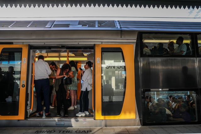 SYDNEY, AUSTRALIA - MARCH 08: Commuters board a train at Central Station on March 08, 2023 in Sydney, Australia. Sydney trains ground to a halt shortly before the afternoon peak due to an unspecified communications issue, according to media reports. Even after some service resumed, commuters were being advised to make other arrangements. (Photo by Roni Bintang/Getty Images)