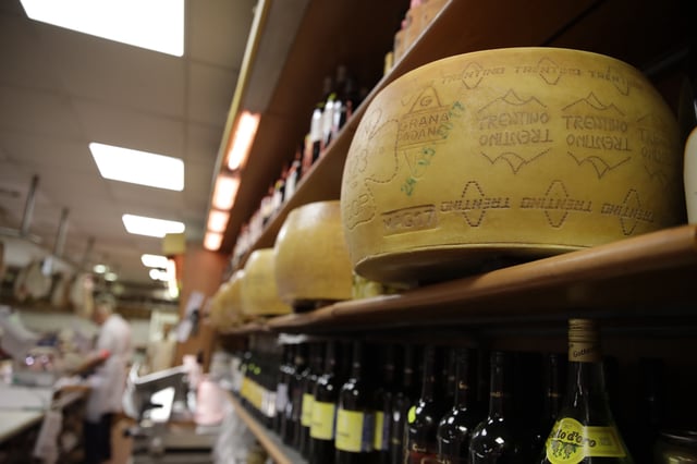 FILE - Wheels of Parmesan cheese are stored in a deli in Rome, Thursday, Oct. 3, 2019. (AP Photo/Alessandra Tarantino, File)