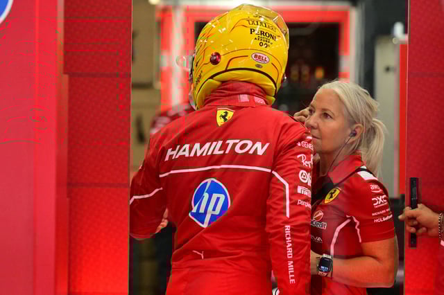 Ferrari&#39;s British driver Lewis Hamilton with his physio Angela Cullen in the garage during the third practice session ahead of the Formula One British Grand Prix at the Silverstone motor racing circuit in Silverstone, central England, on July 5, 2025.
