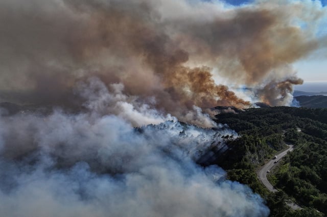 Smoke rises into the sky during a wildfire in the town of Rabia, Syria, in the Latakia countryside, on Saturday.