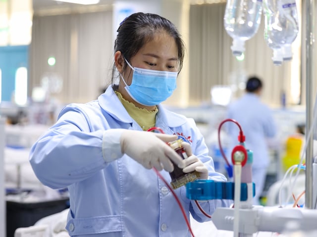 A nurse cares for a hemodialysis patient at the hemodialysis center of Yuping Dong Autonomous County People's Hospital in Tongren, Guizhou province, China, on February 26, 2025. (Photo by Costfoto/NurPhoto via Getty Images)