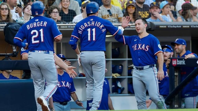 Jul 5, 2025; San Diego, California, USA; Texas Rangers catcher Kyle Higashioka (11) celebrates in the dugout after hitting a two-run home run during the third inning against the San Diego Padres at Petco Park. Mandatory Credit: David Frerker-Imagn Images