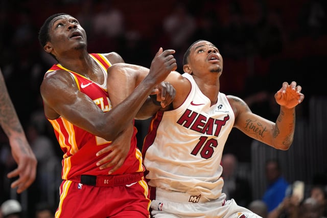 Oct 16, 2024; Miami, Florida, USA; Atlanta Hawks guard Daeqwon Plowden (29) and Miami Heat forward Keshad Johnson (16) battle for rebound position in the second half at Kaseya Center. Mandatory Credit: Jim Rassol-Imagn Images