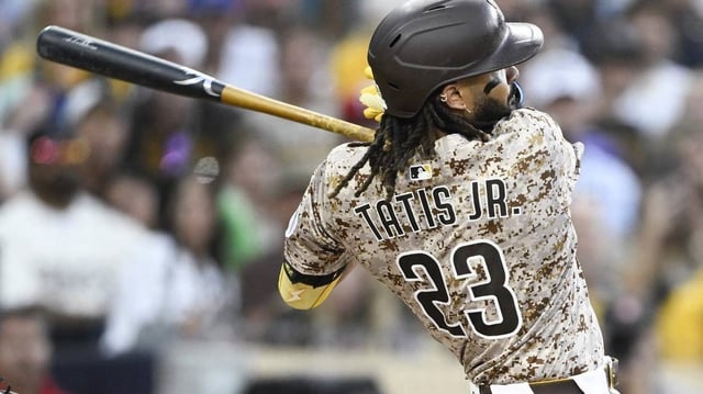 Jul 6, 2025; San Diego, California, USA; San Diego Padres right fielder Fernando Tatis Jr. (23) hits an RBI double during the fourth inning against the Texas Rangers at Petco Park. Mandatory Credit: Denis Poroy-Imagn Images