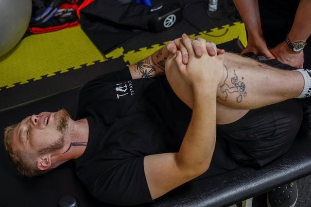 Ukrainian serviceman Oleksiy, 26, who lost most of his left leg after being wounded by an anti-personnel mine, reacts as he exercises at a rehabilitation centre, amid Russia's attack on Ukraine, in Kyiv, Ukraine July 3, 2025. REUTERS/Alina Smutko
