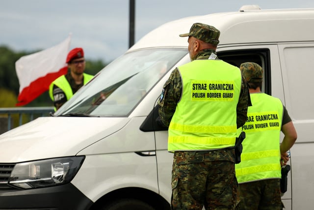 Polish border guards check a vehicle at Polish-German border, as Poland starts controls on borders with Germany, Lithuania over migration, near the German town of Frankfurt an der Oder, in Slubice, Poland, July 7, 2025. REUTERS/Lisi Niesner