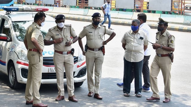 The Bengaluru police stand guard at BMTC bus stand, as coronavirus cases surge in Bengaluru, Wednesday