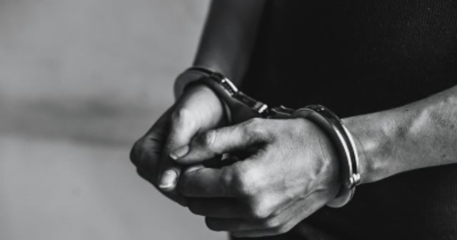 Representative image showing a person in handcuffs