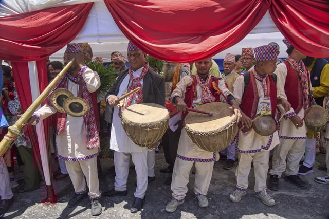 Pro-monarchy supporters play traditional music as they line up to offer birthday wishes to former King Gyanendra Shah at his residence, in Kathmandu, Nepal, Monday, July 7, 2025. (AP Photo/Niranjan Shrestha)