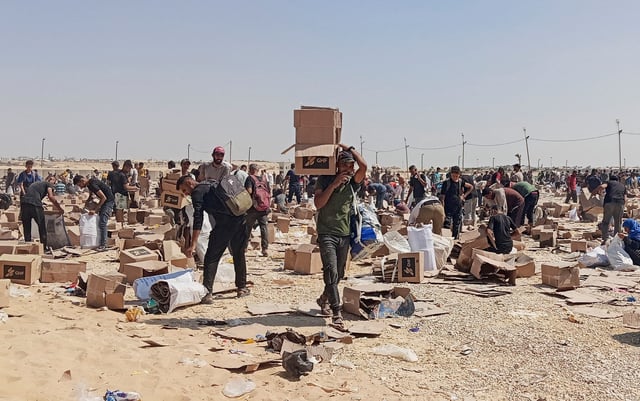Palestinians collect what remains of relief supplies from the distribution center of the U.S.-backed Gaza Humanitarian Foundation, in Rafah, in the southern Gaza Strip, June 5, 2025. REUTERS/Stringer/File Photo