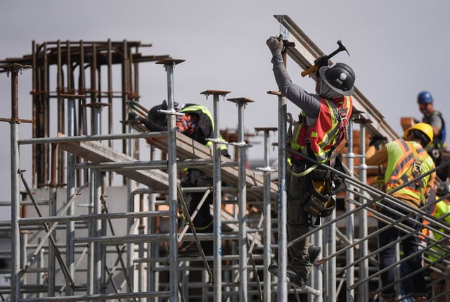 Construction workers work at the site of a condo tower under construction, in Delta, B.C., on Wednesday, July 2, 2025. THE CANADIAN PRESS/Darryl Dyck