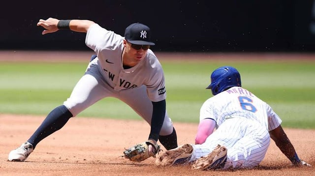 Jul 6, 2025; New York City, New York, USA;New York Mets left fielder Starling Marte (6) beats the tag by New York Yankees shortstop Anthony Volpe (11) at second base during the first inning at Citi Field. Mandatory Credit: Vincent Carchietta-Imagn Images
