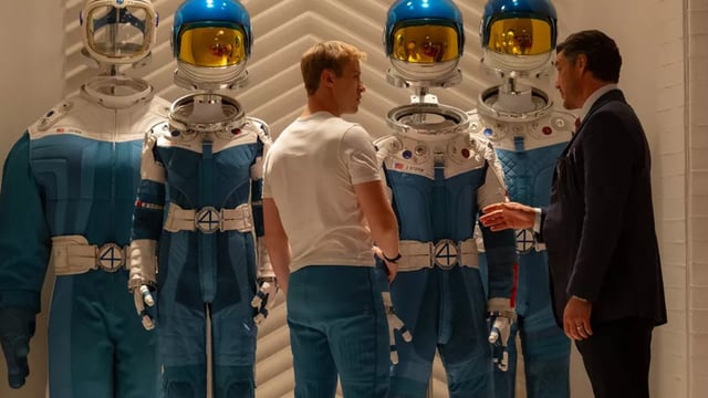 Johnny and Reed looking at the Fantastic Four suits.