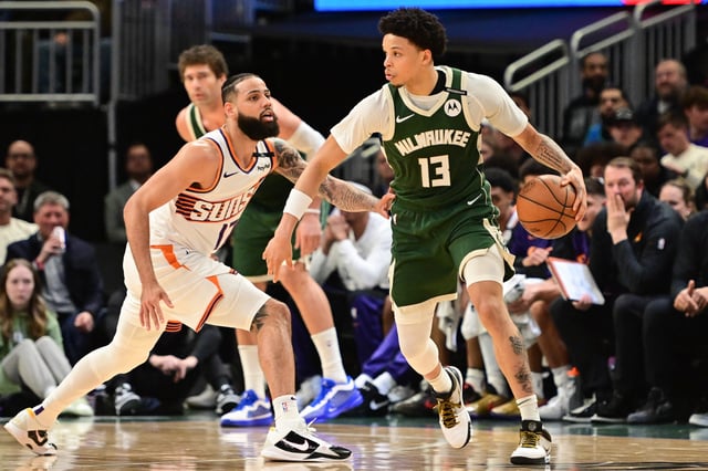 Apr 1, 2025; Milwaukee, Wisconsin, USA; Milwaukee Bucks guard Ryan Rollins (13) drives for the basket against Phoenix Suns forward Cody Martin (17) in the second quarter at Fiserv Forum. Mandatory Credit: Benny Sieu-Imagn Images/File Photo