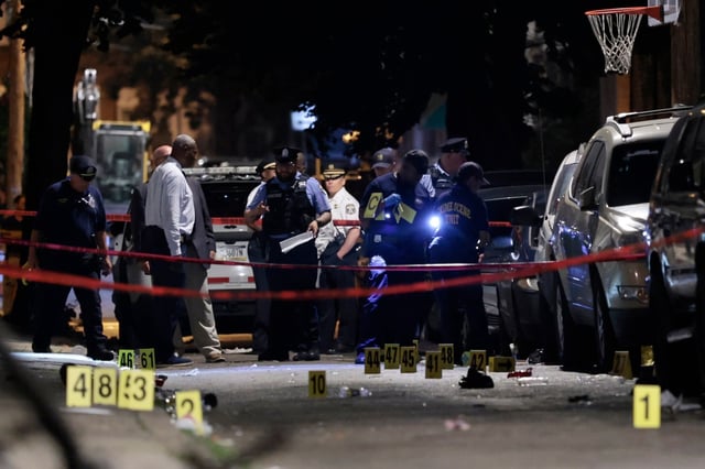 Police investigate the scene of an overnight shooting on Monday, July 7, 2025, in Philadelphia. (Elizabeth Robertson/The Philadelphia Inquirer via AP)