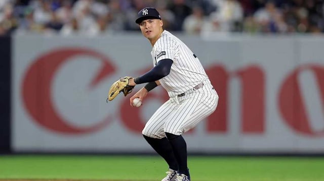 Jun 16, 2025; Bronx, New York, USA; New York Yankees shortstop Anthony Volpe (11) throws out Los Angeles Angels center fielder Jo Adell (not pictured) on a ground ball during the eighth inning at Yankee Stadium. Mandatory Credit: Brad Penner-Imagn Images