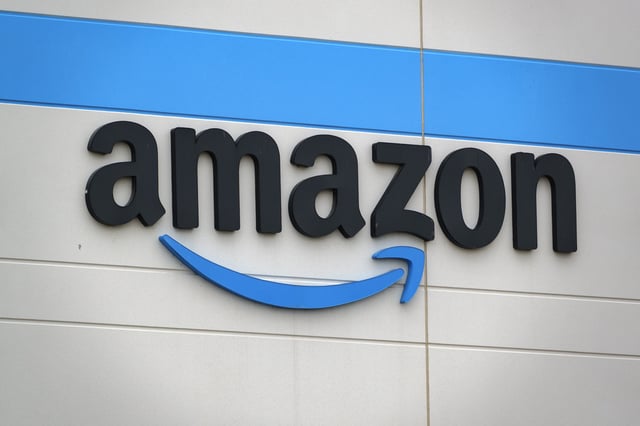The Amazon logo is displayed on a sign outside of a distribution center on May 3, 2025 in San Diego, California.