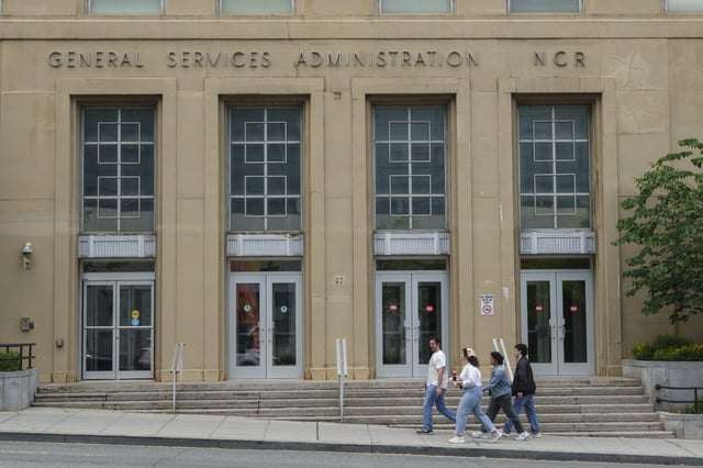 People walk by the General Services Administration building on June 1, 2025 in Washington, DC. (Photo by Kevin Carter/Getty Images)