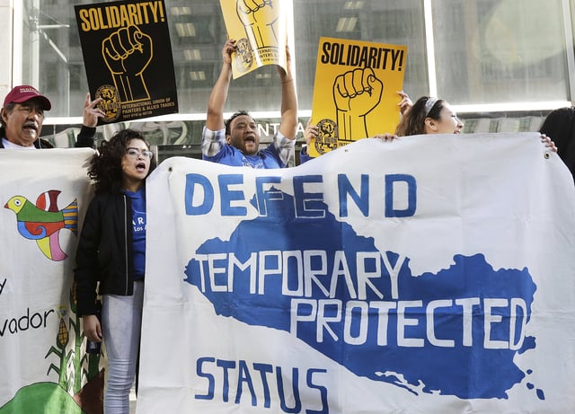 FILE - Supporters of temporary protected status immigrants hold signs and cheer at a rally before a conference announcing a lawsuit against the Trump administration over its decision to end a program letting immigrants live and work legally in the United States outside of a federal courthouse in San Francisco, March 12, 2018. (AP Photo/Jeff Chiu, File)