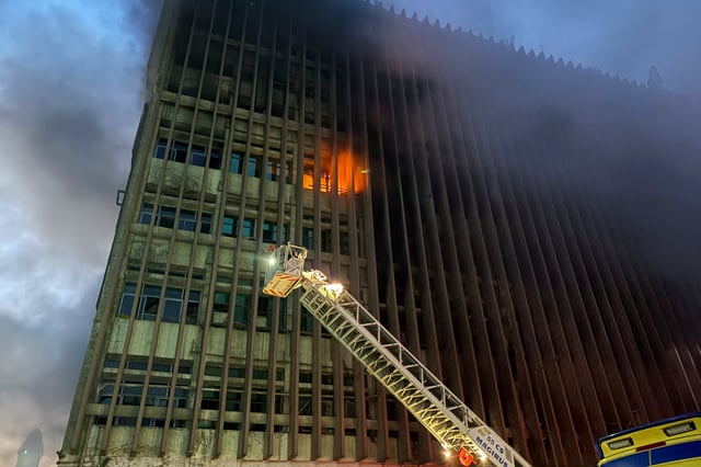 Fire fighters battle flames after a fire broke out in a telecommunications building in central Cairo, Sunday, July 7, 2025. (AP Photo/Ahmed Hatem)