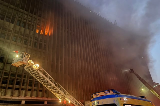 Fire fighters battle flames after a fire broke out in a telecommunications building in central Cairo, Sunday, July 7, 2025. (AP Photo/Ahmed Hatem)