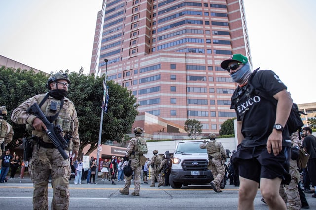 U.S. Marines protect the U.S. Customs and Border Protector cars while they leave the Edward R. Roybal Federal and Detention Center building during a protest against U.S. Immigration and Customs Enforcement (ICE) raids and the presence of the U.S. military in civilian spaces on July 4, 2025 in Los Angeles, California.