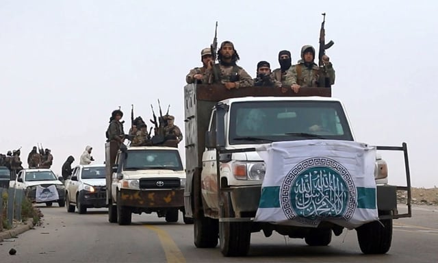 This photo released Dec. 4, 2018 by the al-Qaida-affiliated Ibaa News Agency, shows al-Qaida-linked fighters driving their vehicles during a military drill in northern Syria. It took the al-Qaida-linked militants only few days to capture more than two dozen towns and villages in and around Idlib province, cementing the groupÄôs control over an area in northwestern Syria the size of neighboring Lebanon. The push by members of Hayat Tahrir al-Sham, or HTS, is the most serious blow to a September cease-fire for Idlib brokered by Russia and Turkey, and puts tens of thousands of civilians at risk of losing medical support due to a drop in aid from western agencies. (Ibaa News Agency, via AP)