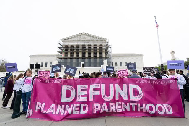 Activists opposing funding for Planned Parenthood demonstrate in front of the Supreme Court on April 2.