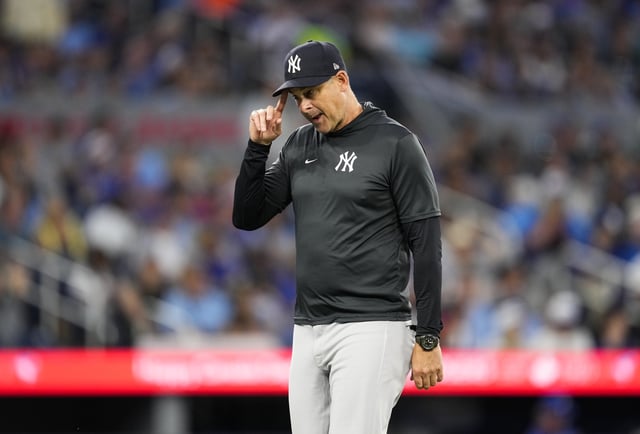 TORONTO, ON - JULY 3: Manager Aaron Boone of the New York Yankees walks back to the dugout after making a pitching change in the fifth inning against the Toronto Blue Jays in their MLB game at the Rogers Centre on July 3, 2025 in Toronto, Ontario, Canada.