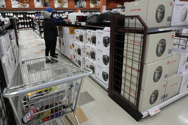 FILE – Shoppers shop electric rice cookers imported from Japan and Korea at the H Mart in Niles, Ill., April 3, 2025. (AP Photo/Nam Y. Huh, File)