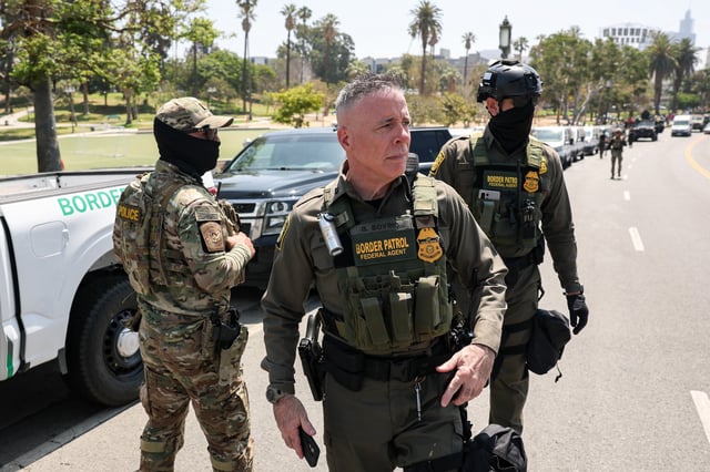 Gregory K. Bovino, US Border Patrol El Centro Sector Chief, can be seen walking on the scene as a large group of federal law enforcement officers arrive at MacArthur Park in Los Angeles, California, on July 7, 2025. (Photo by Patrick T. Fallon / AFP) (Photo by PATRICK T. FALLON/AFP via Getty Images)