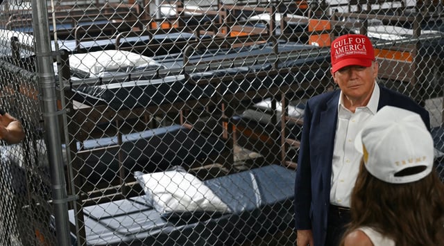 President Donald Trump speaks with Secretary of Homeland Security Kristi Noem as they tour a migrant detention center, dubbed "Alligator Alcatraz," in Ochopee, Florida, July 1, 2025. (Andrew Caballero-Reynolds/AFP via Getty Images)