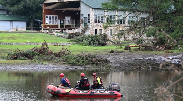 A search and rescue team looks for people along the Guadalupe River near a damaged building at Camp Mystic in Hunt, Texas, on July 7, 2025, following severe flash flooding that occurred during the July 4 holiday weekend. (RONALDO SCHEMIDT / AFP)