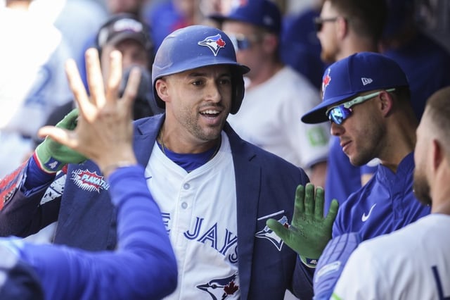 Toronto Blue Jays' George Springer (4) celebrates in the dug out after hitting a two run home run off Los Angeles Angels pitcher Jack Kochanowicz (41) during third inning MLB baseball action in Toronto, Saturday, July 5, 2025. THE CANADIAN PRESS/Chris Young