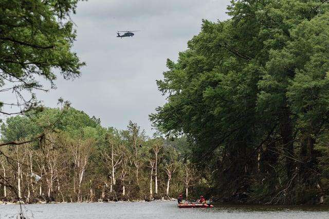 A Blackhawk Helicopter can be seen flying over the Guadalupe River near Camp Mystic looking for survivors or the remains of victims swept up in the flash flooding on July 7, 2025, in Hunt, Texas. (Photo by Jim Vondruska/Getty Images)