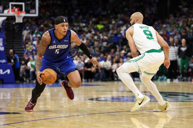Apr 27, 2025; Orlando, Florida, USA; Orlando Magic forward Paolo Banchero (5) is guarded by Boston Celtics guard Derrick White (9) in the second quarter during game four of first round for the 2025 NBA Playoffs at Kia Center. Mandatory Credit: Nathan Ray Seebeck-Imagn Images/File Photo