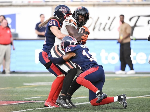 B.C. Lions' Jevon Cottoy, centre, is tackled by Montreal Alouettes' Najee Murray (12) and Marc-Antoine Dequoy (24) during the first half in Montreal on Saturday
