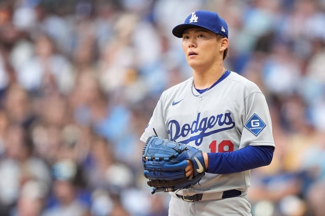 Dodgers starting pitcher Yoshinobu Yamamoto looks on during the first inning of their game against the Milwaukee Brewers on Monday night in Milwaukee. Yamamoto failed to get out of the first inning in the shortest outing of his MLB career in a 9-1 loss. (AP Photo/Aaron Gash)