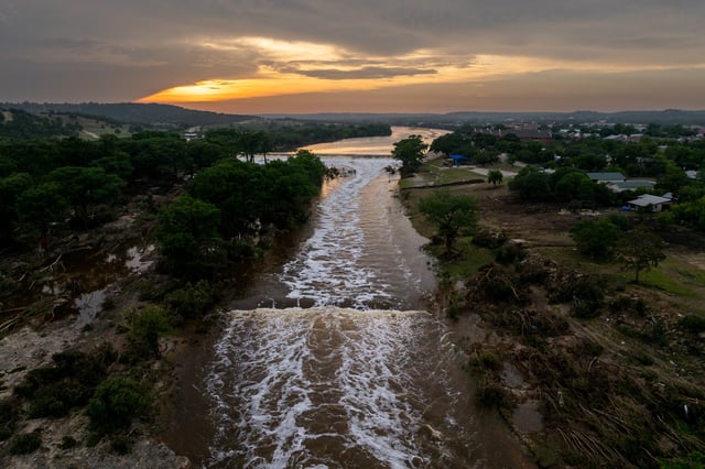 KERRVILLE, TEXAS – JULY 06: In an aerial view, the sun sets over the Guadalupe River on July 06, 2025 in Kerrville, Texas. Heavy rainfall caused severe flooding along the Guadalupe River in central Texas, leaving more than 80 people reported dead. (Photo by Brandon Bell/Getty Images)