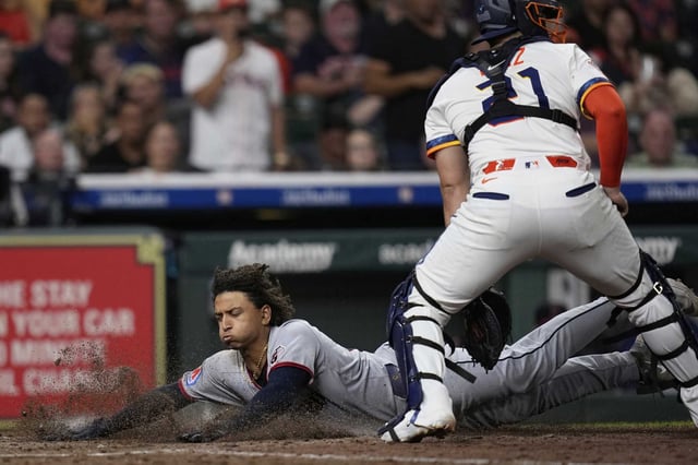 Cleveland&#39;s Bo Naylor slides in to cap the Guardian&#39;s go-ahead inning in the sixth as Astros catcher Yainer Diaz waits for the throw.